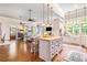 Stylish open kitchen with a large island and modern appliances, connecting seamlessly to the living area at 8901 Watkins Mill Rd, Winston, GA 30187