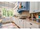 Bright and airy kitchen featuring tile backsplash, stainless steel appliances, and plenty of counter space at 8901 Watkins Mill Rd, Winston, GA 30187