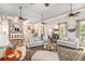 Bright living room with neutral tones, ceiling fans, and a seamless flow to other living spaces at 8901 Watkins Mill Rd, Winston, GA 30187