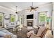 Cozy living room with fireplace, plush seating, and large windows offering serene outdoor views at 8901 Watkins Mill Rd, Winston, GA 30187