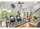 Vaulted ceiling living room boasts many windows, hardwood floors, staircase, and stylish decor at 8901 Watkins Mill Rd, Winston, GA 30187