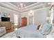 Spacious main bedroom with trey ceiling, chandelier, sitting area and hardwood floors at 8901 Watkins Mill Rd, Winston, GA 30187