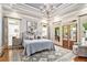 Serene main bedroom with trey ceiling, chandelier, sitting area, and private access to backyard at 8901 Watkins Mill Rd, Winston, GA 30187