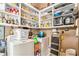 Organized pantry with white shelves and appliances, including a washer and dryer at 8901 Watkins Mill Rd, Winston, GA 30187