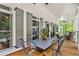 Inviting covered porch with a dining table and chairs offering a relaxing outdoor living space at 8901 Watkins Mill Rd, Winston, GA 30187