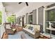 Spacious covered porch with comfortable seating, perfect for relaxing and enjoying the outdoors at 8901 Watkins Mill Rd, Winston, GA 30187