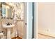 Charming powder room with pedestal sink, unique wallpaper, and wood paneling at 8901 Watkins Mill Rd, Winston, GA 30187