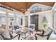 Lovely sunroom with wood ceiling, hardwood floors, many windows, and seating at 8901 Watkins Mill Rd, Winston, GA 30187