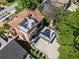 Aerial view of the property featuring upper balcony with sunshade and lower patio, and mature trees at 1216 E Rock Springs Ne Rd, Atlanta, GA 30306