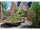 Landscaped backyard with a planter pot, bench, and river rock accents creates a serene retreat at 1216 E Rock Springs Ne Rd, Atlanta, GA 30306