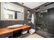 Modern bathroom with wood countertop, glass shower, and dark gray tiling at 1216 E Rock Springs Ne Rd, Atlanta, GA 30306