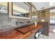 Unique bathroom featuring wood vanity and fixtures, decorative tile and an adjacent bedroom at 1216 E Rock Springs Ne Rd, Atlanta, GA 30306