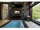 Bathroom showcasing a soaking tub, television, and nature view from the picture window at 1216 E Rock Springs Ne Rd, Atlanta, GA 30306