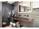 Bathroom features custom wood vanity with sinks, wall tile, and stylish decor, creating a spa-like retreat at 1216 E Rock Springs Ne Rd, Atlanta, GA 30306