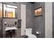Gray tiled powder room featuring modern fixtures and decor at 1216 E Rock Springs Ne Rd, Atlanta, GA 30306