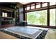 Modern bathroom with soaking tub, a built-in TV, and large picture window at 1216 E Rock Springs Ne Rd, Atlanta, GA 30306