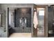 Modern bathroom showcasing a luxurious walk-in shower and elegant, decorative wall tiling and bronze fixtures at 1216 E Rock Springs Ne Rd, Atlanta, GA 30306