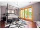 Spacious bedroom with a four-poster bed, decorative rug, and natural light, creating a serene retreat at 1216 E Rock Springs Ne Rd, Atlanta, GA 30306