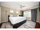 Bright bedroom with hardwood floors, a ceiling fan, and natural light from the large window at 1216 E Rock Springs Ne Rd, Atlanta, GA 30306