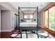 Comfortable bedroom featuring a four-poster bed, modern decor, and natural light, enhancing the inviting space at 1216 E Rock Springs Ne Rd, Atlanta, GA 30306