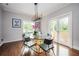 Elegant dining room features a glass table, contemporary chandelier, and natural light from French doors at 1216 E Rock Springs Ne Rd, Atlanta, GA 30306
