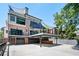 Rear exterior view featuring multiple levels, covered parking, and decks at 1216 E Rock Springs Ne Rd, Atlanta, GA 30306