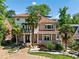 Beautiful two-story home boasts a tile roof, brick accents, manicured landscaping, and palm trees at 1216 E Rock Springs Ne Rd, Atlanta, GA 30306