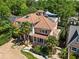 Charming home with a red tile roof, manicured front yard, palm trees, and white pillar front porch at 1216 E Rock Springs Ne Rd, Atlanta, GA 30306