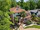 Charming home with a red tile roof, manicured front yard, palm trees, and white pillar front porch at 1216 E Rock Springs Ne Rd, Atlanta, GA 30306