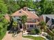 Charming home with a red tile roof, manicured front yard, palm trees, and white pillar front porch at 1216 E Rock Springs Ne Rd, Atlanta, GA 30306