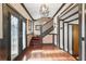 Grand foyer boasts dark-trimmed doors, staircase, hardwood floors, and stylish chandelier at 1216 E Rock Springs Ne Rd, Atlanta, GA 30306