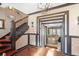 Inviting foyer featuring dark trim, hardwood floors, a staircase, and an open doorway at 1216 E Rock Springs Ne Rd, Atlanta, GA 30306