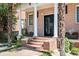 Classic brick home with charming front entrance featuring a porch, columns, and glass door at 1216 E Rock Springs Ne Rd, Atlanta, GA 30306