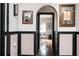 Stylish hallway with hardwood floors, paneled walls, and an arched doorway leading to dining area at 1216 E Rock Springs Ne Rd, Atlanta, GA 30306
