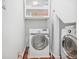 Functional laundry room with washer, dryer and built-in storage cabinets at 1216 E Rock Springs Ne Rd, Atlanta, GA 30306