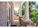 Covered porch with white columns offers a peaceful space to relax outdoors, surrounded by lush greenery at 1216 E Rock Springs Ne Rd, Atlanta, GA 30306