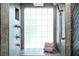 Modern shower with glass block window, bronze hardware, and neutral towels, emphasizing luxury and functionality at 1216 E Rock Springs Ne Rd, Atlanta, GA 30306