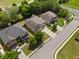 Aerial view of three homes in a neighborhood with green lawns and mature trees at 1314 Bentley Estates Dr, Dacula, GA 30019