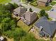 Aerial view of backyards in a neighborhood, featuring green lawns and mature trees at 1314 Bentley Estates Dr, Dacula, GA 30019