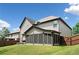 The exterior backyard with a screened in porch at 1314 Bentley Estates Dr, Dacula, GA 30019