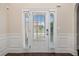 Elegant front door with sidelights, decorative trim, and hardwood floors at 1314 Bentley Estates Dr, Dacula, GA 30019