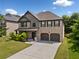 Well-maintained two-story home with brick facade, two-car garage, and a lush green lawn at 1314 Bentley Estates Dr, Dacula, GA 30019