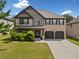 Charming two-story brick home with a well-manicured lawn and a two-car garage at 1314 Bentley Estates Dr, Dacula, GA 30019