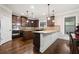 Modern kitchen with stainless steel appliances, granite countertops, and dark wood cabinets at 1314 Bentley Estates Dr, Dacula, GA 30019