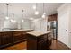 Spacious kitchen with hardwood floors, granite countertops, and stainless steel refrigerator at 1314 Bentley Estates Dr, Dacula, GA 30019
