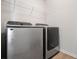 Convenient laundry room featuring modern, stainless steel, front-loading washer and dryer at 1314 Bentley Estates Dr, Dacula, GA 30019