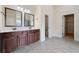 Main bathroom featuring dual sinks, dark wood cabinetry, and marble countertops at 1314 Bentley Estates Dr, Dacula, GA 30019
