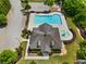 Aerial view of a community pool area with lush landscaping and a fountain at 1314 Bentley Estates Dr, Dacula, GA 30019