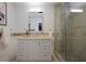 Modern bathroom with stylish vanity, decorative mirror, and a glass-enclosed shower with mosaic tile accents at 2222 Hill Nw St, Atlanta, GA 30318