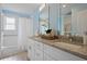 Light and airy bathroom with dual sinks, granite countertops, and a separate tub and shower at 2222 Hill Nw St, Atlanta, GA 30318